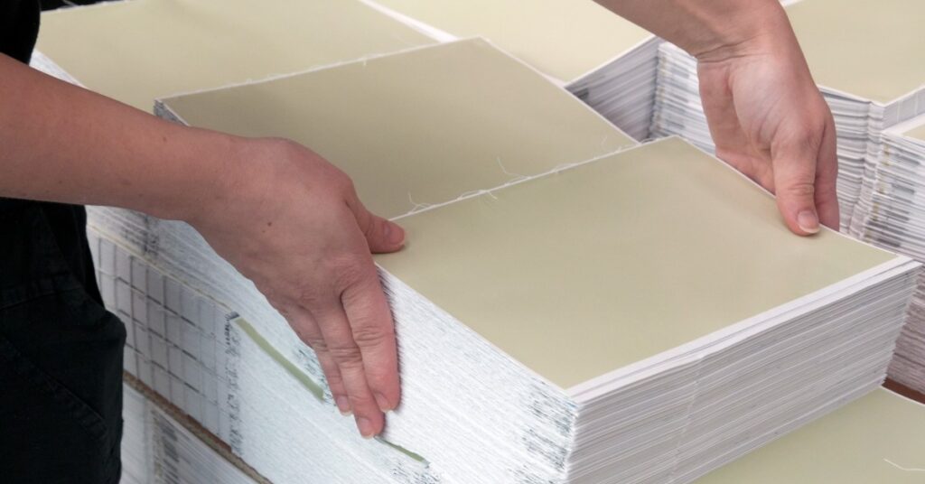 Woman aligning stacks of paper